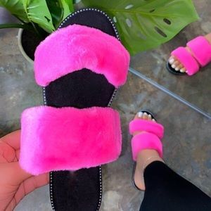 Pink fluffy sandals with studs around the insole